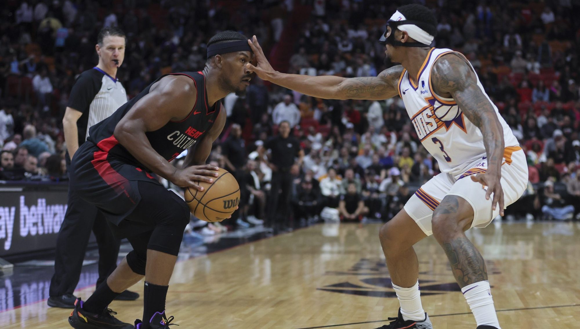 Jan 29, 2024; Miami, Florida, USA; Miami Heat forward Jimmy Butler (22) is guarded by Phoenix Suns guard Bradley Beal (3) during the fourth quarter at Kaseya Center.