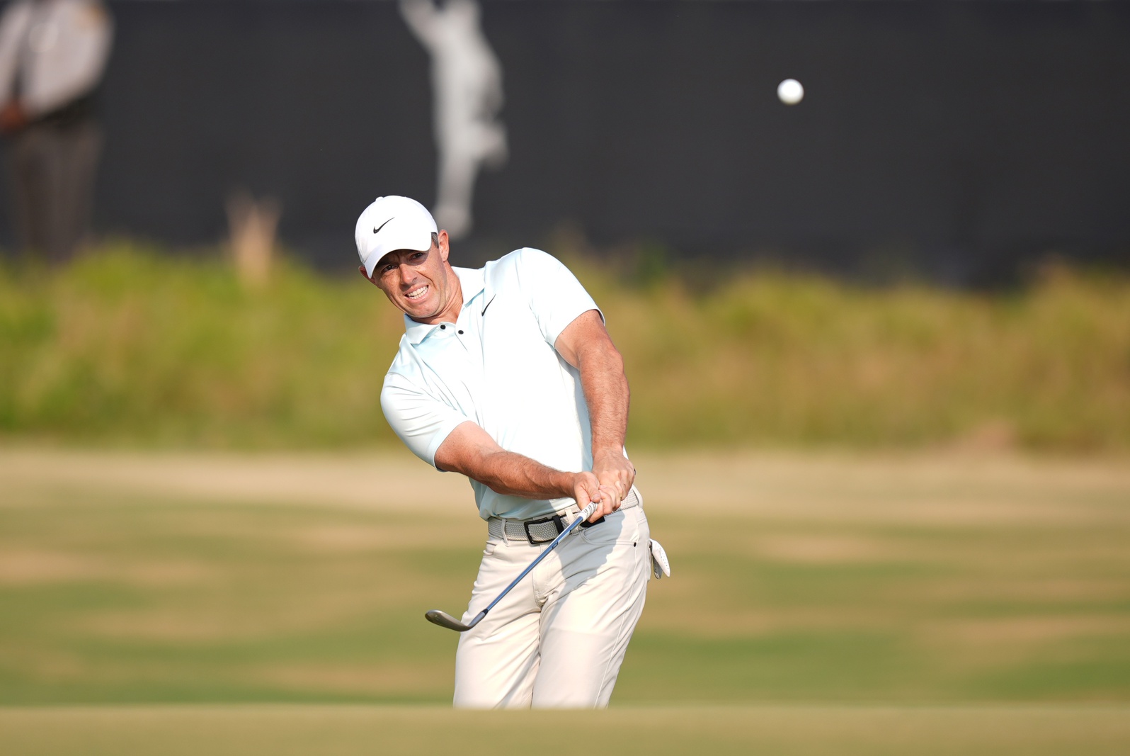 Jun 16, 2024; Pinehurst, North Carolina, USA; Rory McIlroy pitches onto the eighteenth green during the final round of the U.S. Open golf tournament.