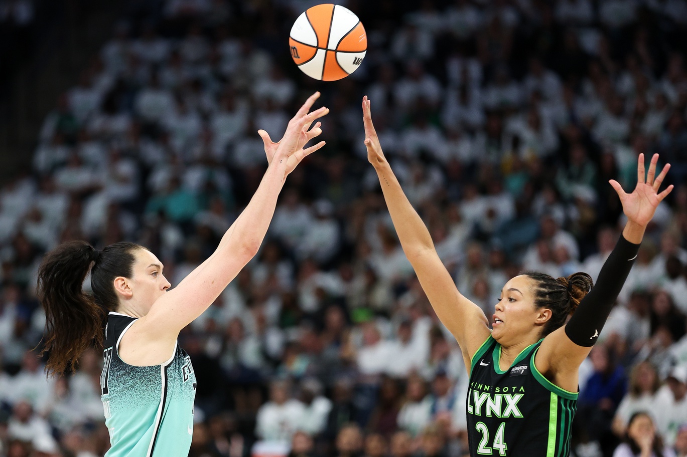 Oct 16, 2024; Minneapolis, Minnesota, USA; New York Liberty forward Breanna Stewart (30) shoots as Minnesota Lynx forward Napheesa Collier (24) defends during the second half of game three of the 2024 WNBA Finals at Target Center.