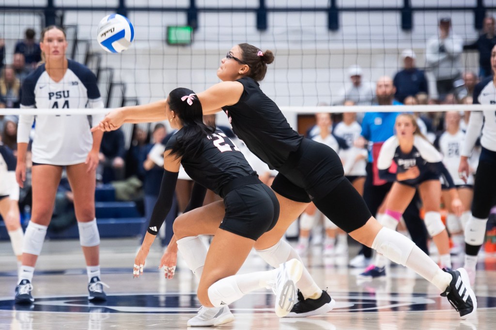 Nebraska's Rebekah Allick, right, lunges to pass the ball during a Big Ten volleyball match against Penn State at Rec Hall on Friday, Nov. 29, 2024, in State College, Pa.