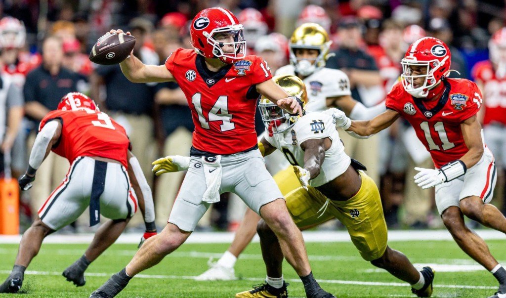 Jan 2, 2025; New Orleans, LA, USA; Georgia Bulldogs quarterback Gunner Stockton (14) passes against Notre Dame Fighting Irish defensive lineman RJ Oben (9) during the second half at Caesars Superdome.