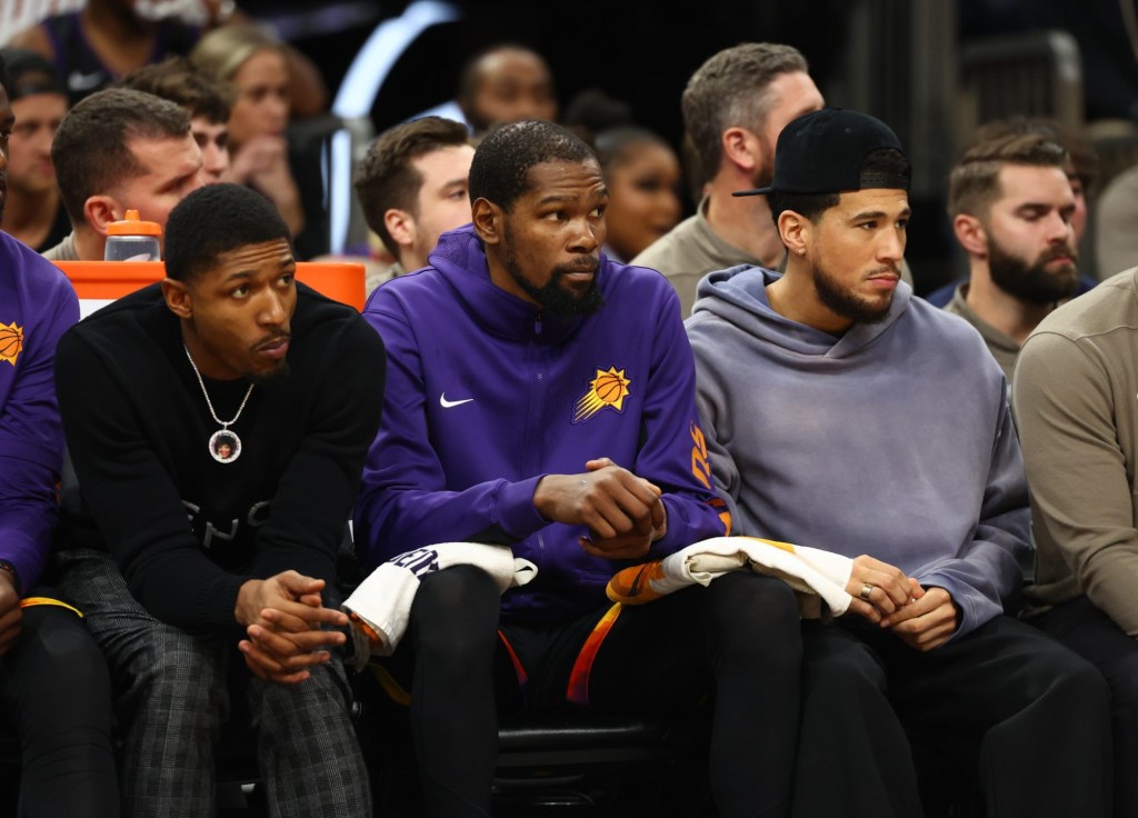 Dec 1, 2023; Phoenix, Arizona, USA; Phoenix Suns guard Bradley Beal (left) on the bench with forward Kevin Durant (center) and guard Devin Booker against the Denver Nuggets at Footprint Center.