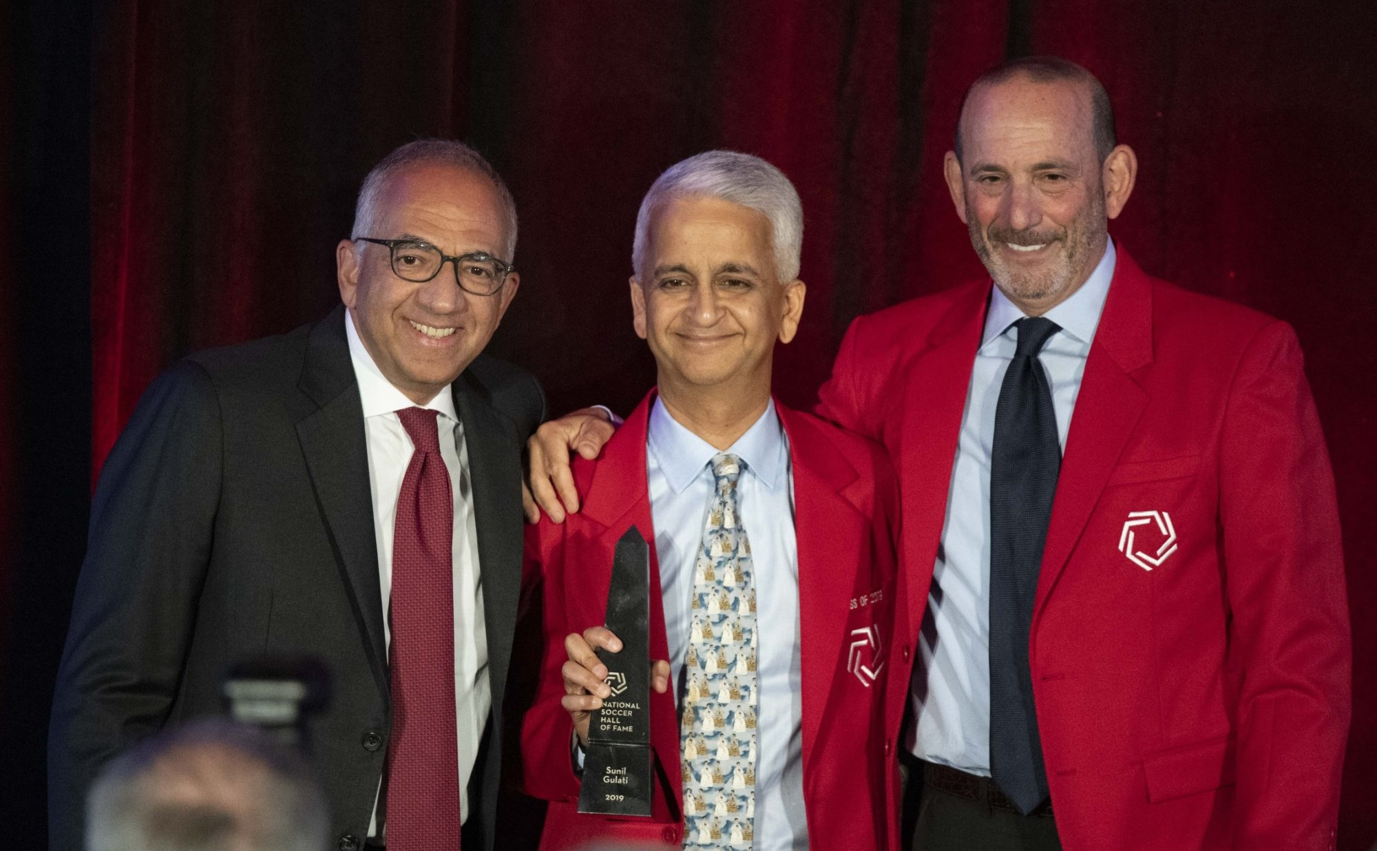 U.S. Soccer Federation president Carlos Cordeiro (left) and Sunil Gulati (center) and MLS commissioner Don Garber (right) pose for a photo.