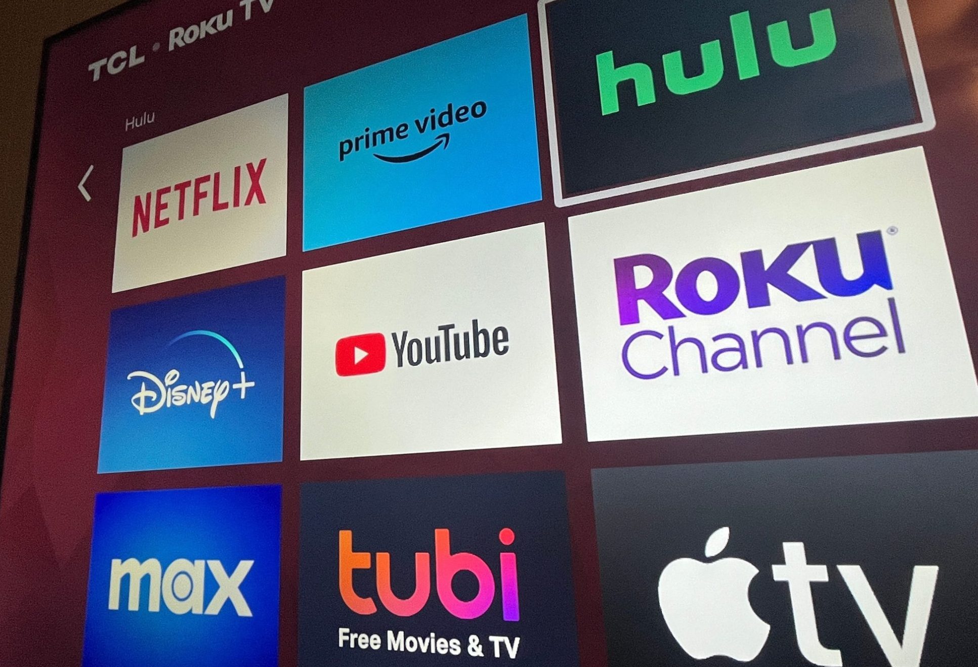 Multiple streaming services appear on a Roku TV.