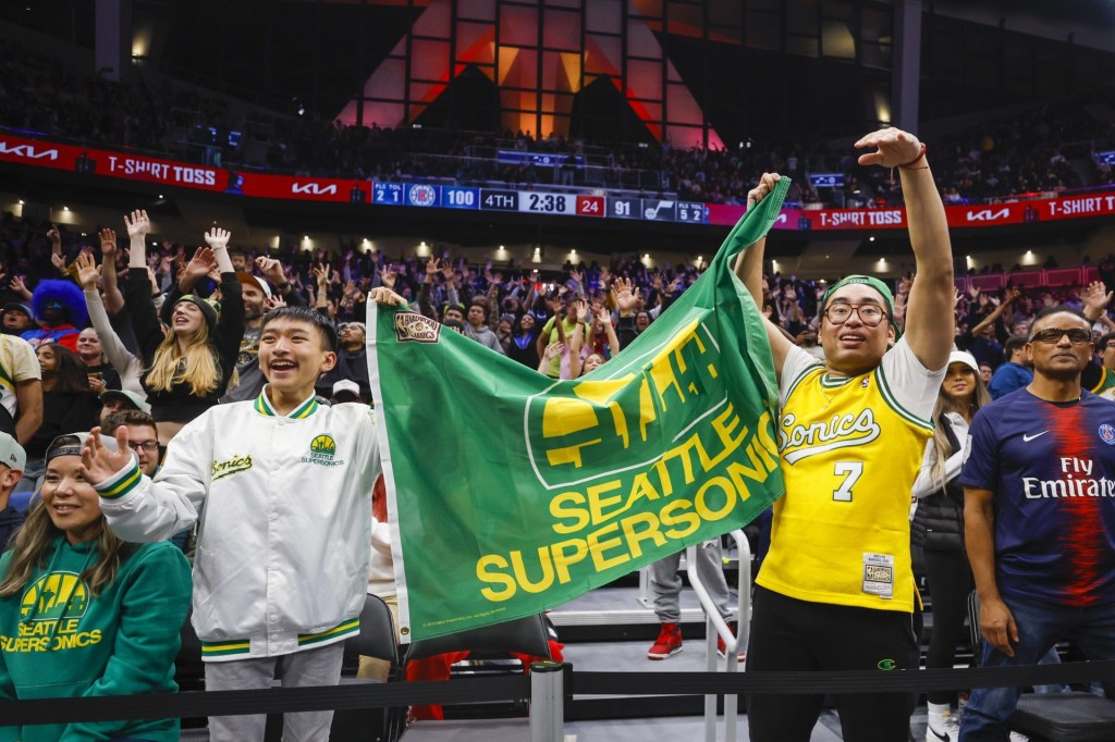 Oct 10, 2023; Seattle, Washington, USA; Fans hold a flag for the Seattle Supersonics during the fourth quarter of a game between the Utah Jazz and LA Clippers at Climate Pledge Arena. Mandatory Credit: 