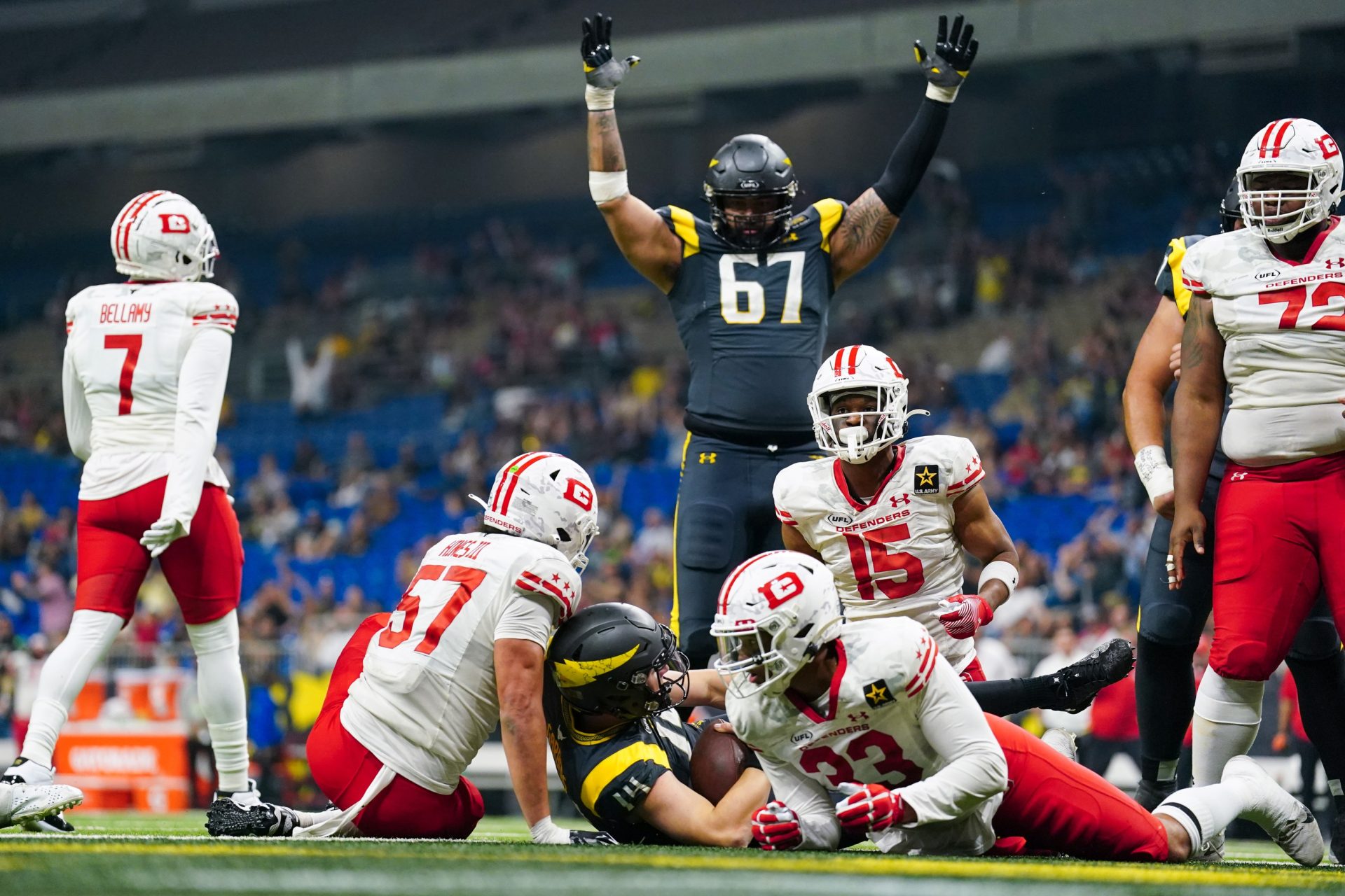 Mar 31, 2024; San Antonio, TX, USA; San Antonio Brahmas quarterback Chase Garbers (14) scores a touchdown between DC Defenders linebacker Anthony Hines III (57), defensive end Trent Harris (33), and cornerback Michael Joseph (15) in the second half at The Alamodome.