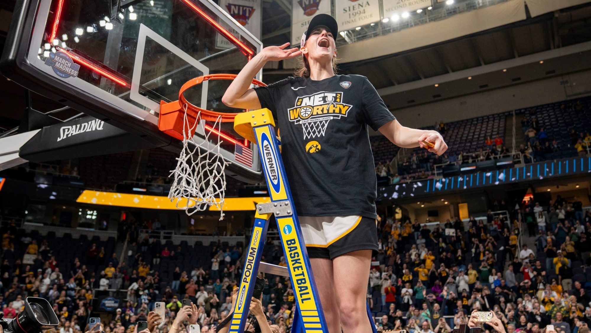 Iowa Hawkeyes guard Caitlin Clark (22) cuts down the net after beating LSU in the Elite 8 round of the NCAA Women's Basketball Tournament between Iowa and LSU at MVP Arena, Monday, April 1, 2024 in Albany, N.Y.