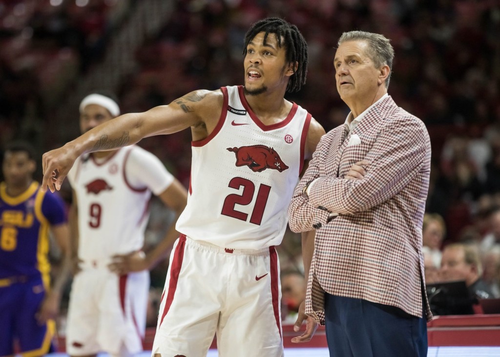 Feb 12, 2025; Fayetteville, Arkansas, USA;  Arkansas Razorbacks guard D.J. Wagner (21) talks with head coach John Calipari during a break in the action against the LSU Tigers at Bud Walton Arena. Arkansas won 70-58. 