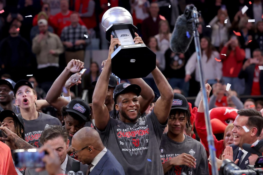 Mar 15, 2025; New York, NY, USA; St. John's Red Storm forward Zuby Ejiofor (24) hoists the championship trophy after defeating the Creighton Bluejays to win the Big East Tournament at Madison Square Garden