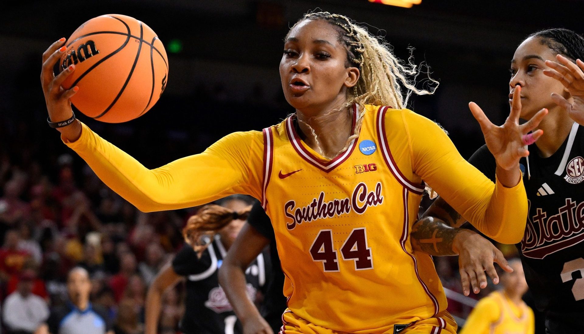 Mar 24, 2025; Los Angeles, California, USA; USC Trojans forward Kiki Iriafen (44) grabs a rebound in front of Mississippi State Bulldogs guard Jerkaila Jordan (2) during the second quarter of an NCAA Tournament second round game at Galen Center.