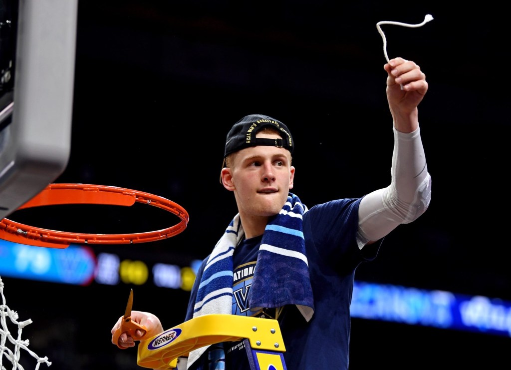 Apr 2, 2018; San Antonio, TX, USA; Villanova Wildcats guard Donte DiVincenzo (10) cuts down the net after beating the Michigan Wolverines in the championship game of the 2018 men's Final Four at Alamodome