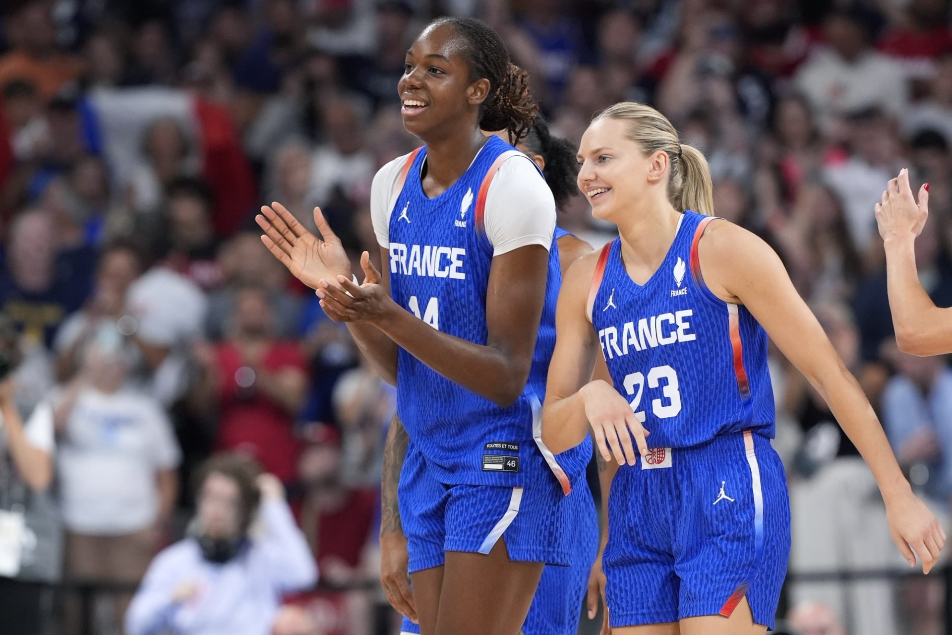 Jul 29, 2024; Villeneuve-d'Ascq, France; France center Dominique Malonga (14) and guard Marine Johannes (23) celebrate after defeating Canada during the Paris 2024 Olympic Summer Games at Stade Pierre-Mauroy