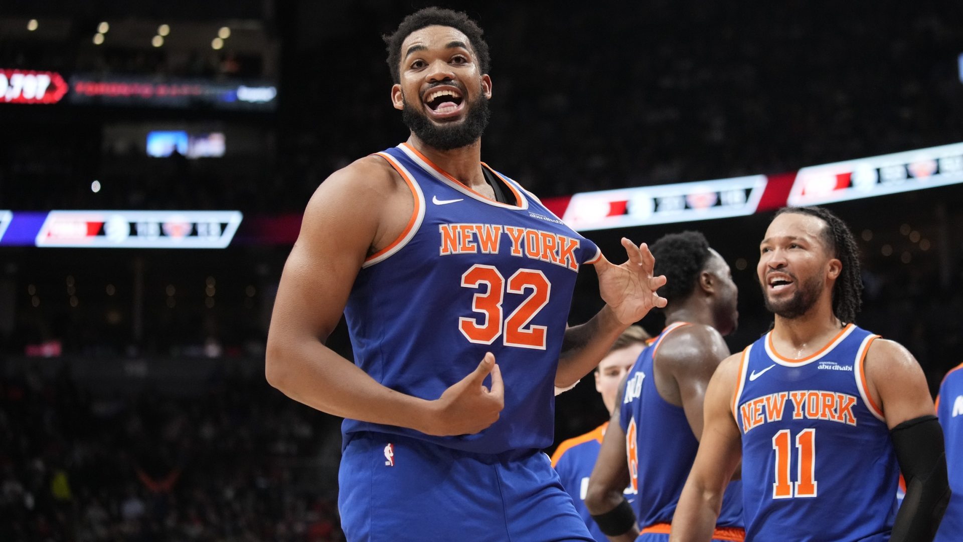 Dec 9, 2024; Toronto, Ontario, CAN; New York Knicks guard Jalen Brunson (11) watches as center Karl-Anthony Towns (32) celebrates after making a three point basket to clinch a win against the Toronto Raptors near the end of the fourth quarter at Scotiabank Arena