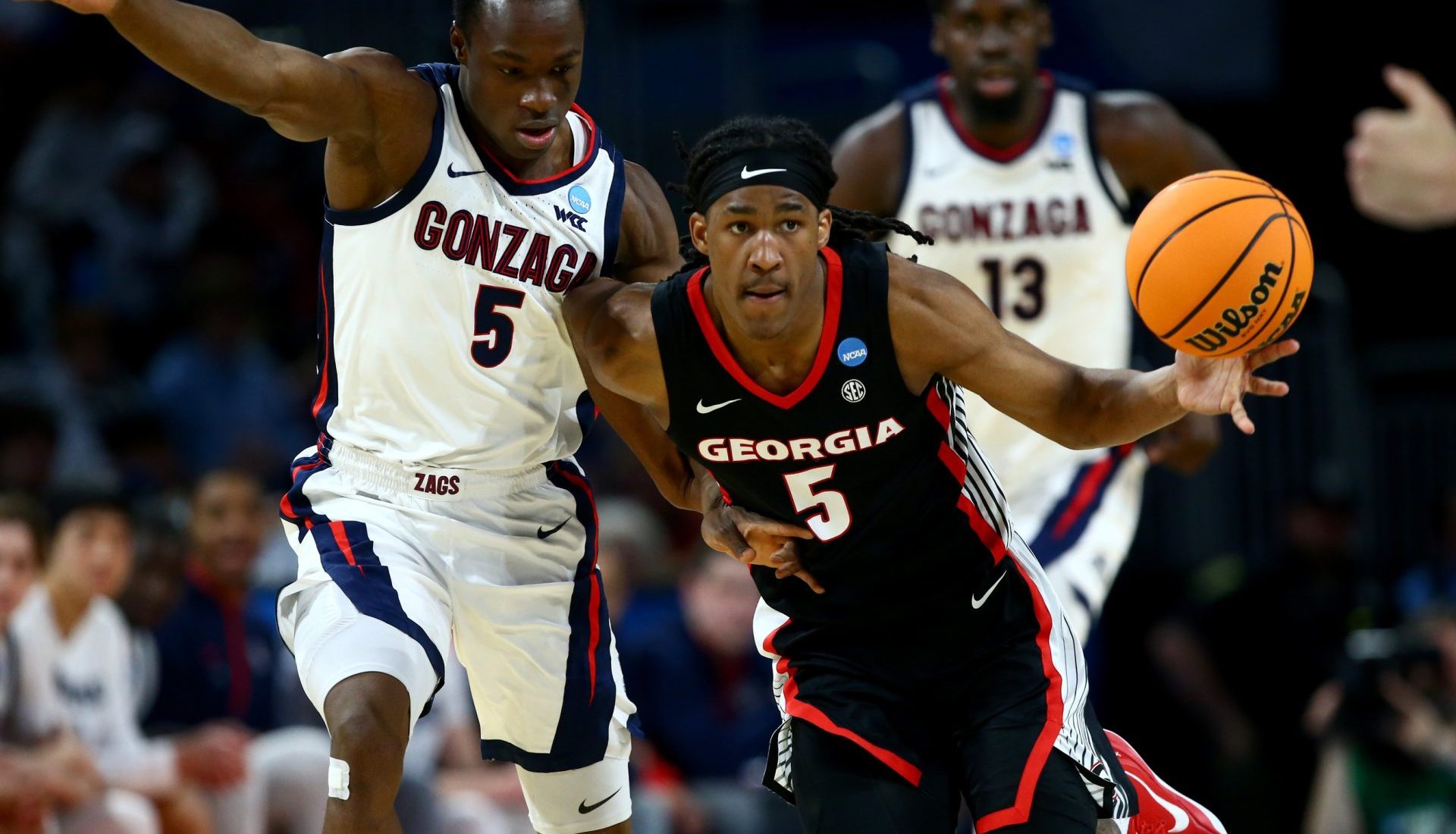 Mar 20, 2025; Wichita, KS, USA; Georgia Bulldogs guard Silas Demary Jr. (5) dribbles against Gonzaga Bulldogs forward Emmanuel Innocenti (5) in the second half of a first round men’s NCAA Tournament game at Intrust Bank Arena.