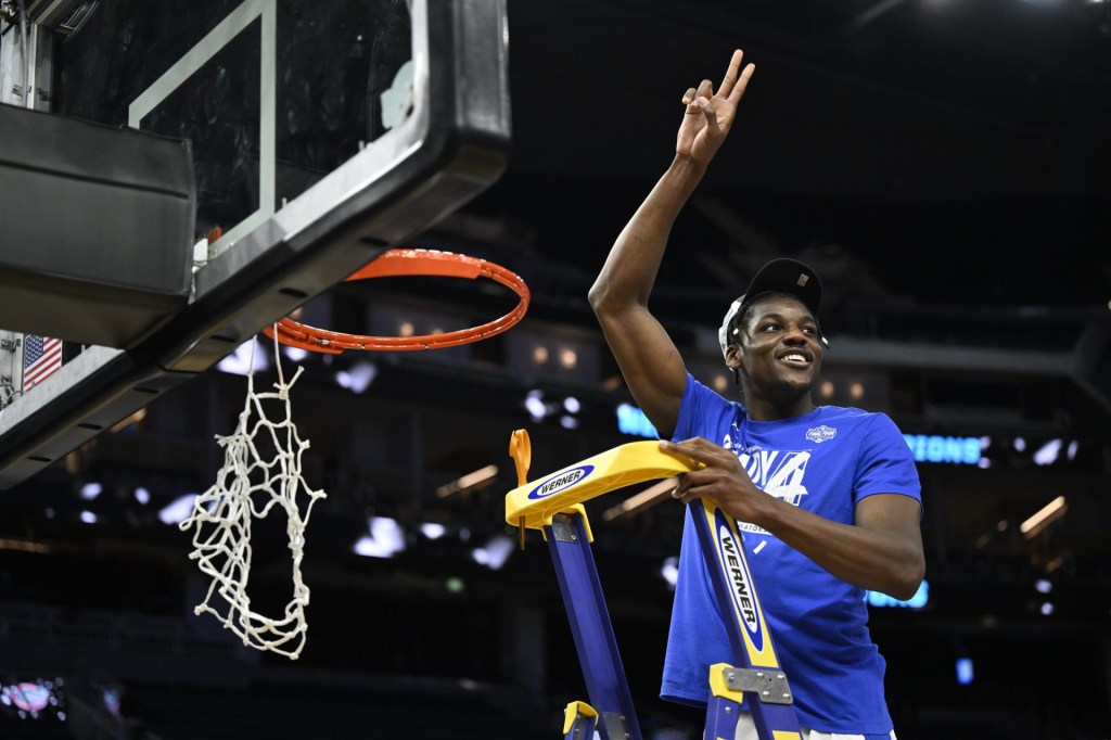 Mar 29, 2025; San Francisco, CA, USA; Florida Gators center Rueben Chinyelu (9) cuts down the net after defeating the Texas Tech Red Raiders during the West Regional final of the 2025 NCAA tournament at Chase Center.