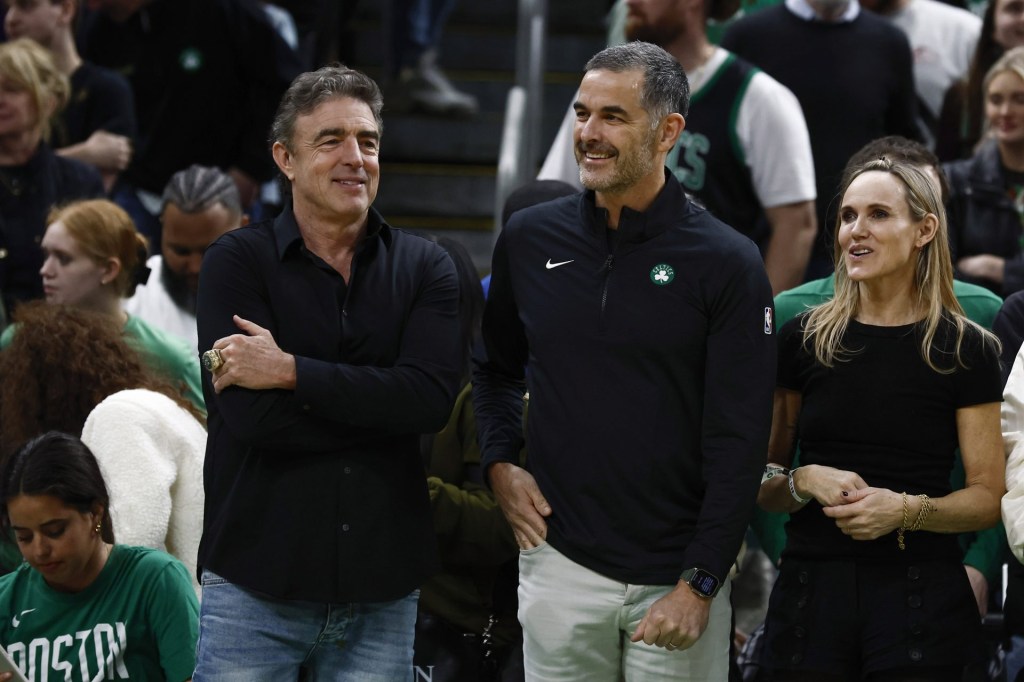Apr 4, 2025; Boston, Massachusetts, USA; Bill Chisholm, center, who leads a group that is buying the Boston Celtics, stands with current owner Wyc Grousbeck and Chisholm’s wife, Kimberly Chisholm before the game between the Boston Celtics and the Phoenix Suns at TD Garden
