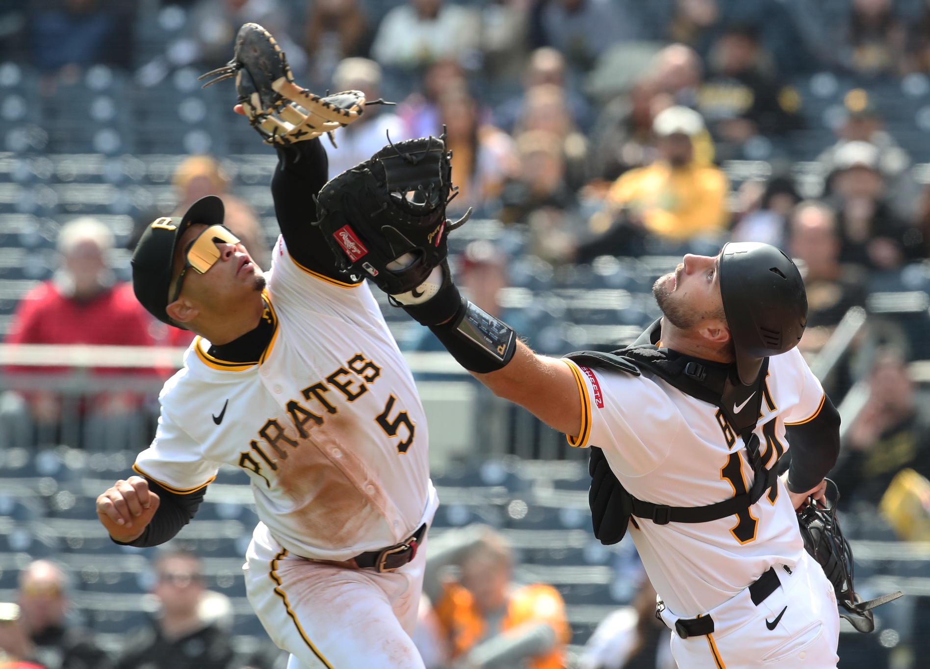 Apr 9, 2025; Pittsburgh, Pennsylvania, USA; Pittsburgh Pirates first baseman Endy Rodriguez (5) and catcher Joey Bart (14) collide attempting to catch a pop-up hit by St. Louis Cardinals designated hitter Willson Contreras (not pictured) during the eighth inning at PNC Park.