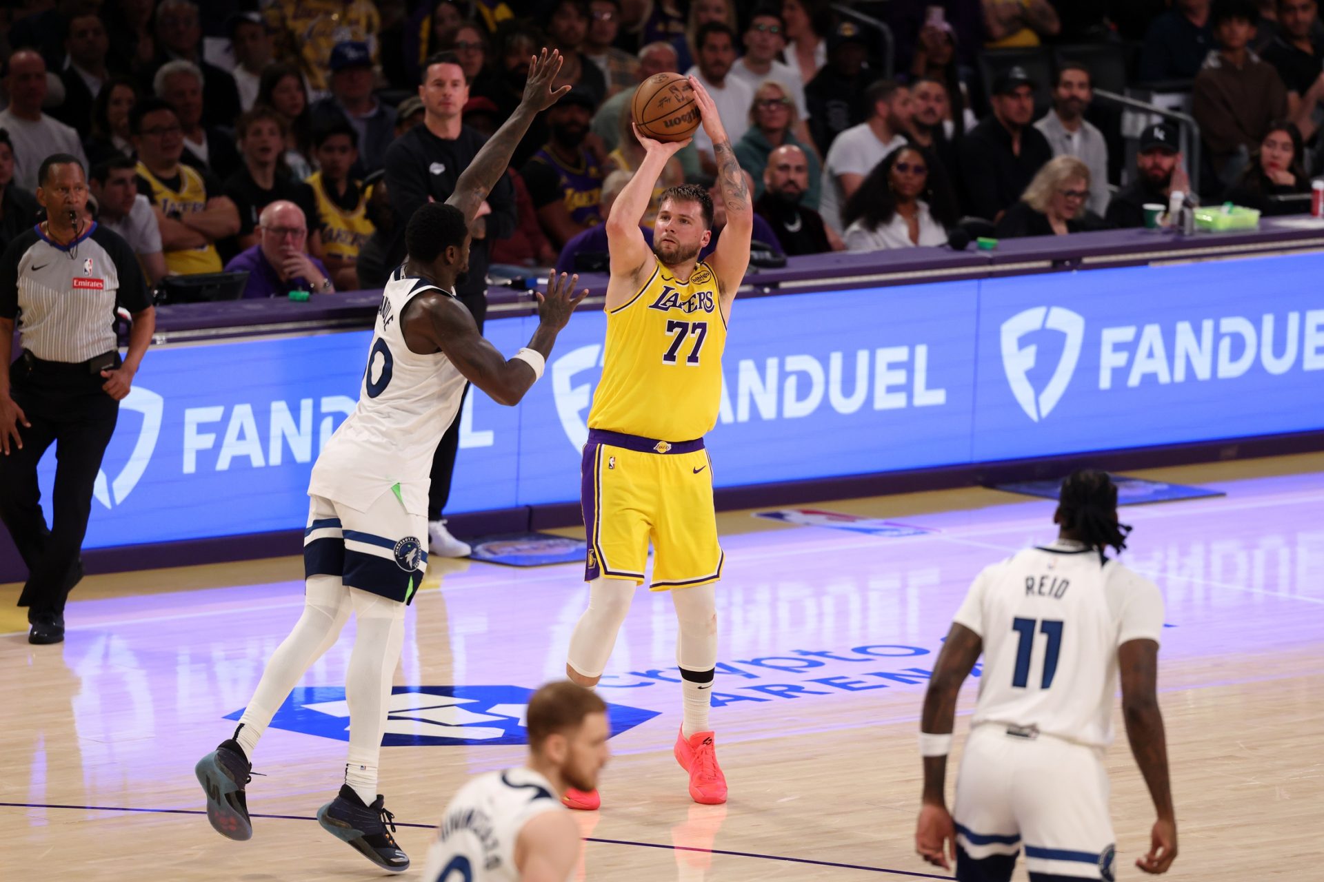 Apr 22, 2025; Los Angeles, California, USA; Los Angeles Lakers guard Luka Doncic (77) shoots the ball over Minnesota Timberwolves forward Julius Randle (30) during the third quarter of game two of first round for the 2024 NBA Playoffs at Crypto.com Arena.