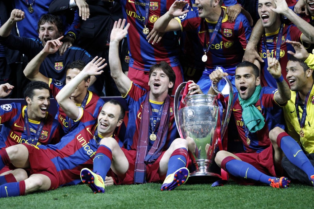 May 28, 2011; London, ENGLAND; FC Barcelona player Lionel Messi (middle) and his teammates celebrate with the championship trophy after defeating Manchester United 3-1 in the 2011 UEFA Champions League final at Wembley Stadium