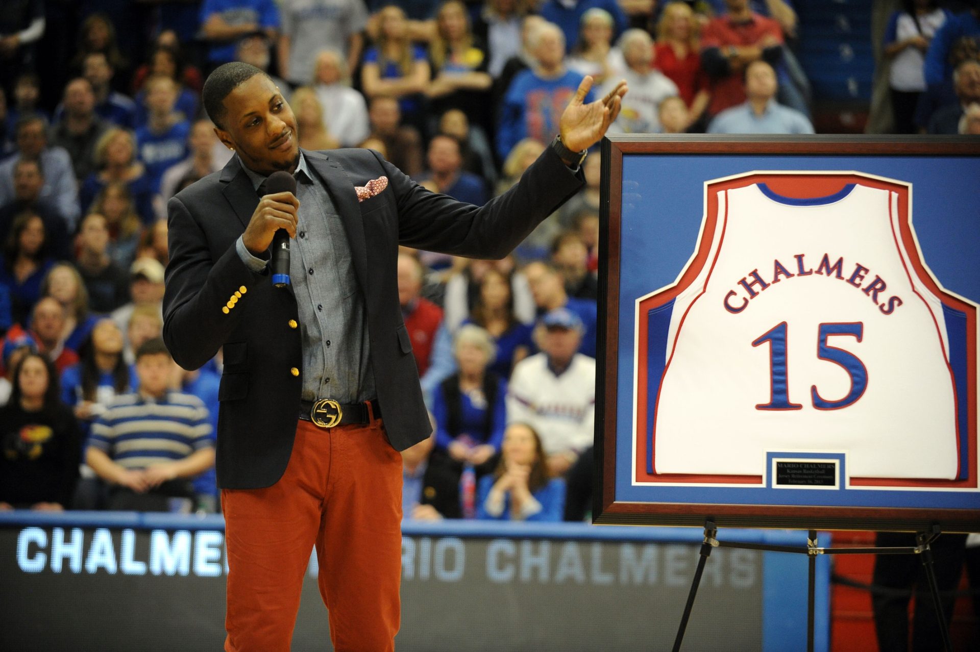 Feb 16, 2013; Lawrence, KS, USA; Former Kansas Jayhawks guard Mario Chalmers talks to the crowd as his jersey is retired during halftime of the game against the Texas Longhorns at Allen Fieldhouse.