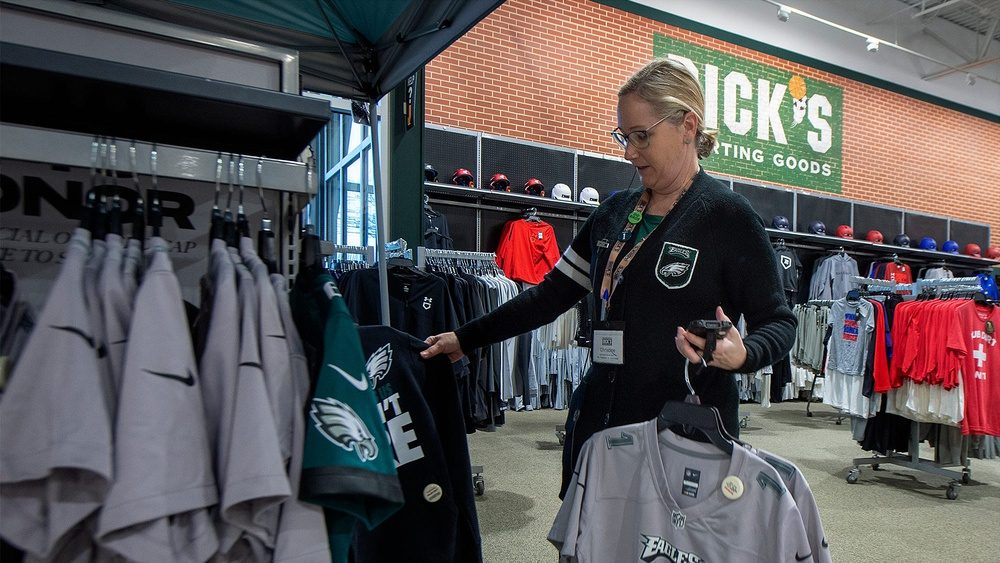 At Dick's Sporting Goods in Fairless Hills, Store Administrative Assistant Christine Vandfermay, of Philadelphia, restocks some Philadelphia Eagles items, Monday, Jan. 30, 2023.