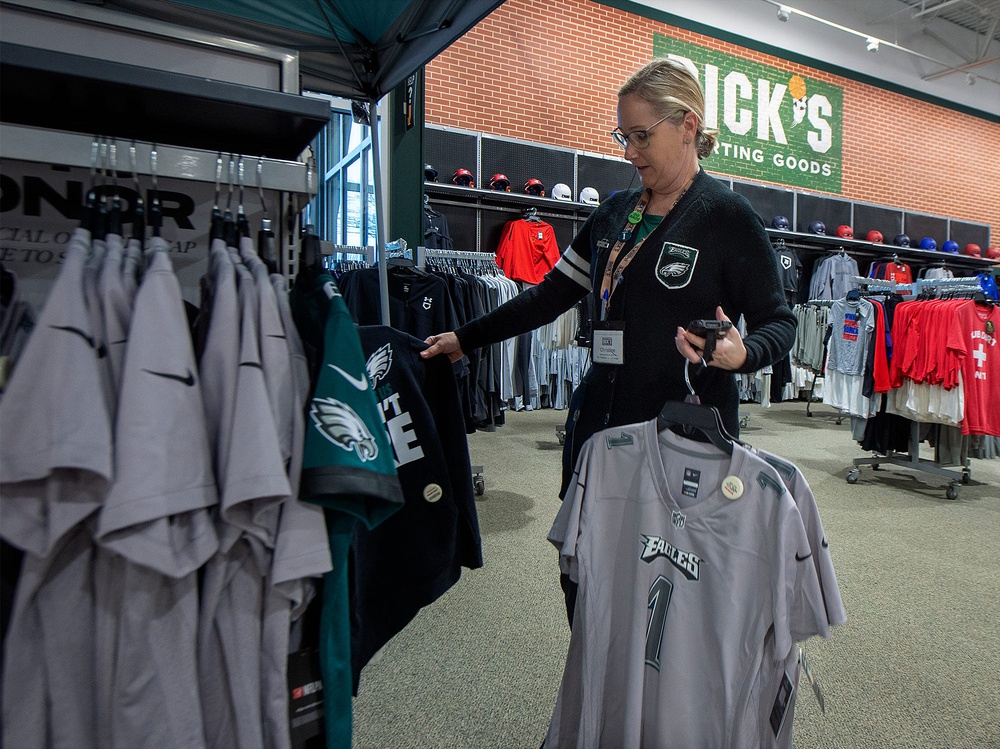 At Dick's Sporting Goods in Fairless Hills, Store Administrative Assistant Christine Vandfermay, of Philadelphia, restocks some Philadelphia Eagles items, Monday, Jan. 30, 2023.