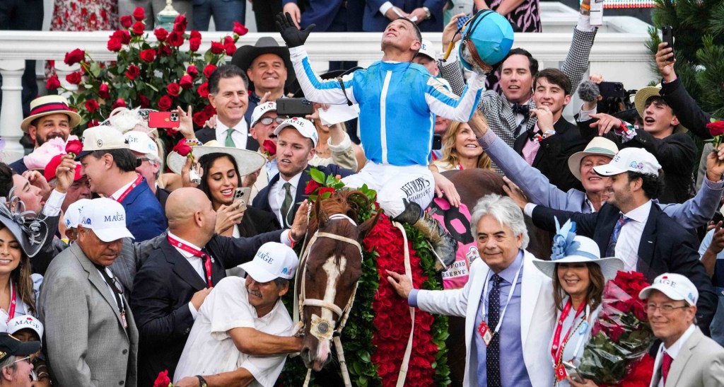 May 6, 2023; Louisville, KY, USA; Jockey Javier Castellano celebrates aboard Mage in the Winner's Circle as trainer trainer Gustavo Delgado , with a hand on the garland of roses, won the 149th Kentucky Derby on Saturday at Churchill Downs in Louisville, Ky. May, 6, 2023.