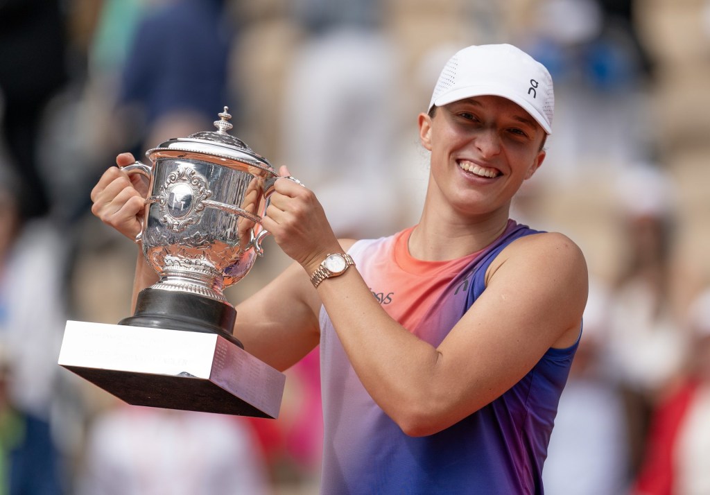 Jun8, 2024; Paris, France; Iga Swiatek of Poland poses with the trophy after winning the women's singles final match against Jasmine Paolini of Italy on day 14 of Roland Garros at Stade Roland Garros.