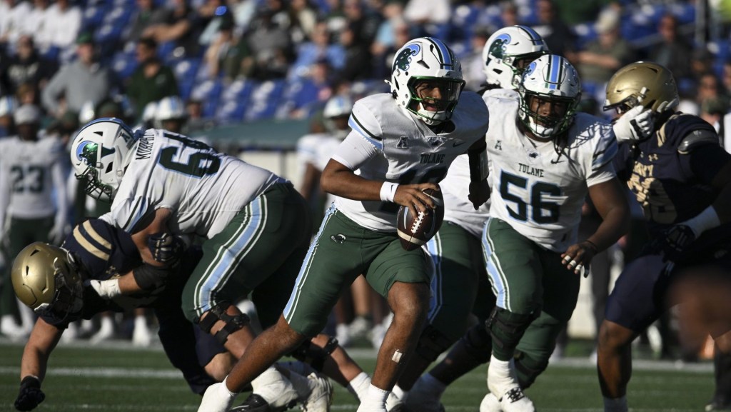 Nov 16, 2024; Annapolis, Maryland, USA; Tulane Green Wave quarterback Darian Mensah (10) rushes during the second half  against the Navy Midshipmen at Navy-Marine Corps Memorial Stadium. 