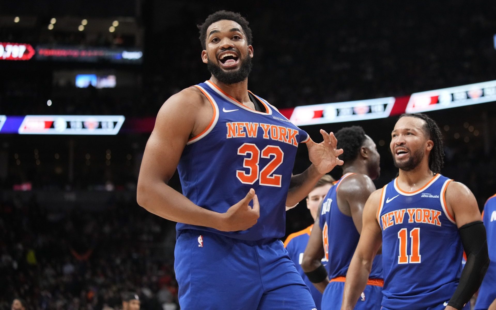 Dec 9, 2024; Toronto, Ontario, CAN; New York Knicks guard Jalen Brunson (11) watches as center Karl-Anthony Towns (32) celebrates after making a three point basket to clinch a win against the Toronto Raptors near the end of the fourth quarter at Scotiabank Arena.
