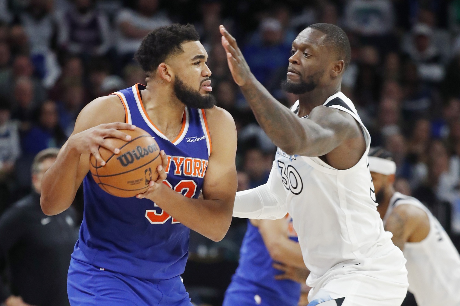 Dec 19, 2024; Minneapolis, Minnesota, USA; New York Knicks forward Karl-Anthony Towns (32) works around Minnesota Timberwolves forward Julius Randle (30) in the third quarter at Target Center.