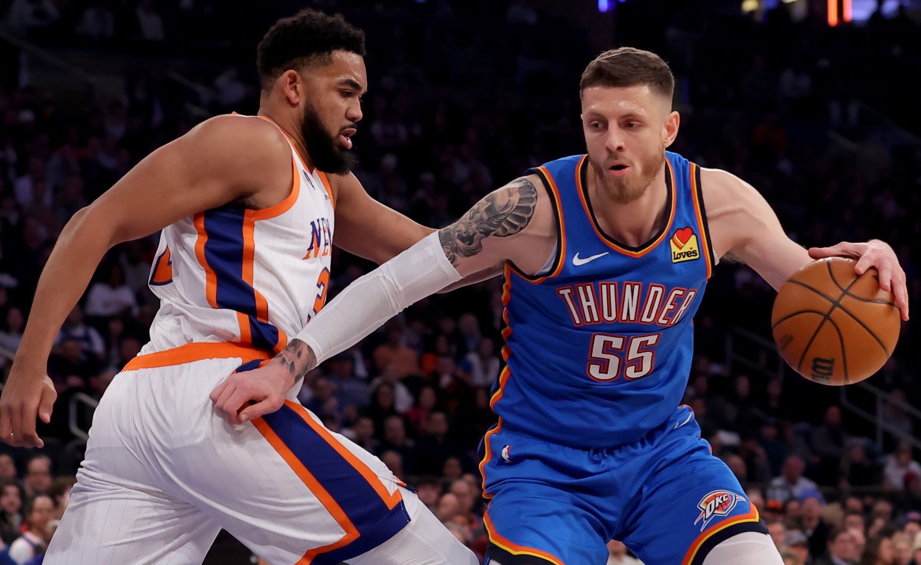 Jan 10, 2025; New York, New York, USA; Oklahoma City Thunder center Isaiah Hartenstein (55) controls the ball against New York Knicks center Karl-Anthony Towns (32) during the first quarter at Madison Square Garden.