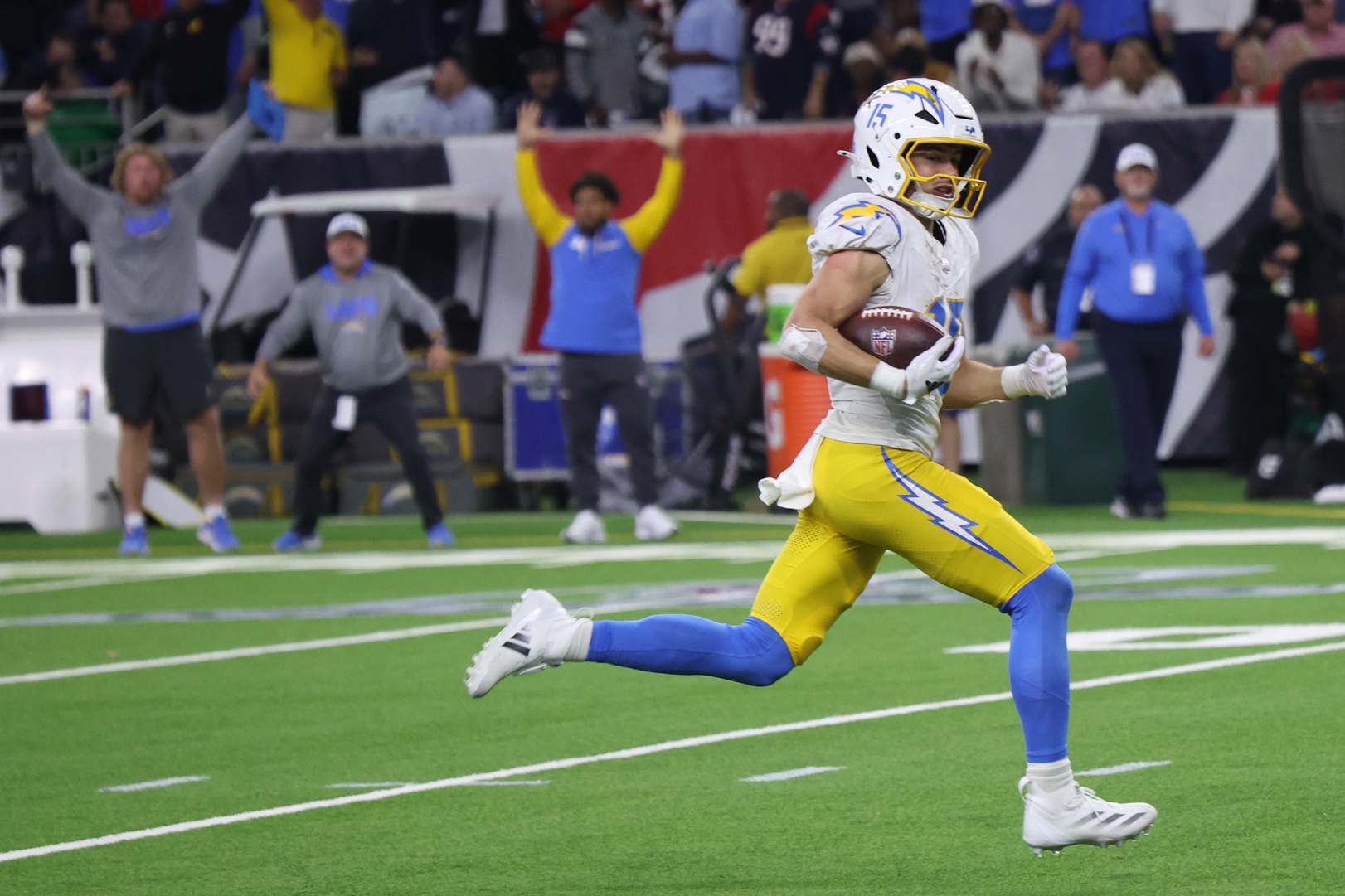 Jan 11, 2025; Houston, Texas, USA; Los Angeles Chargers wide receiver Ladd McConkey (15) scores on a pass in the fourth quarter against the Houston Texans in an AFC wild card game at NRG Stadium.