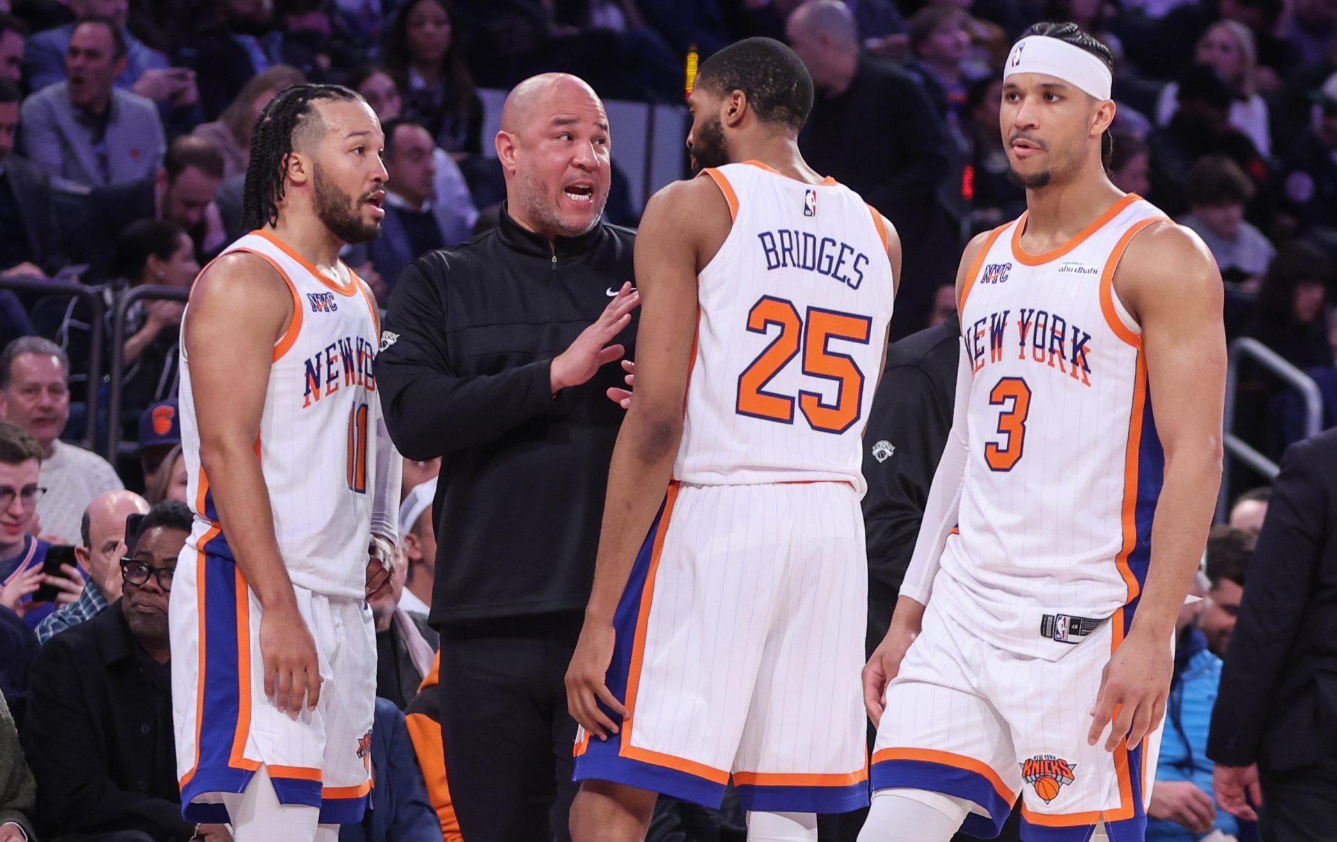 Feb 8, 2025; New York, New York, USA; New York Knicks assistant coach Rick Brunson talks with New York Knicks guard Jalen Brunson (11), forward Mikal Bridges (25), and guard Josh Hart (3) during a timeout in the third quarter against the Boston Celtics at Madison Square Garden.