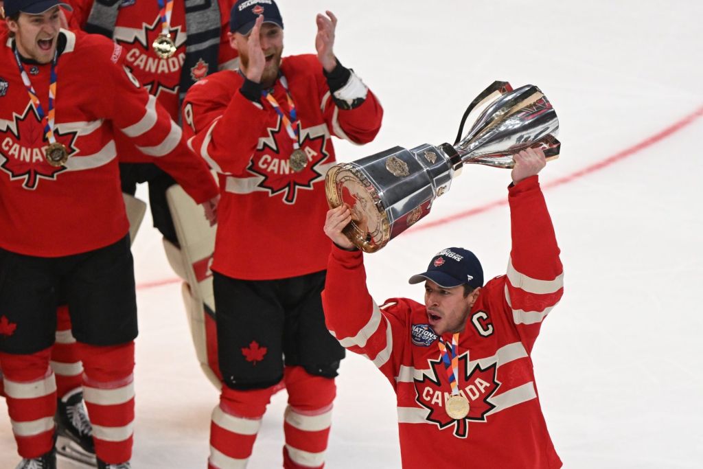 Feb 20, 2025; Boston, MA, USA; [Imagn Images direct customers only] Team Canada forward Sidney Crosby (87) lifts the 4 Nations Face-Off trophy after winning against Team USA in overtime during the 4 Nations Face-Off ice hockey championship game at TD Garden
