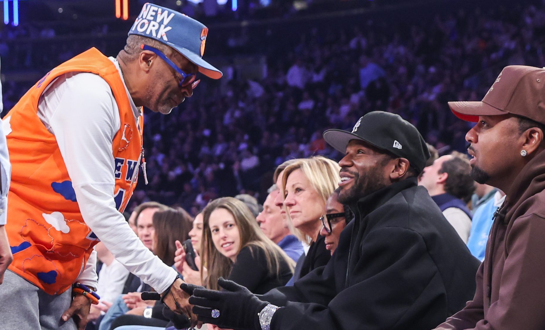 Mar 26, 2025; New York, New York, USA; Actor and filmmaker Spike Lee (l) greets former professional boxer Floyd Mayweather Jr. during the game between the LA Clippers and the New York Knicks at Madison Square Garden.