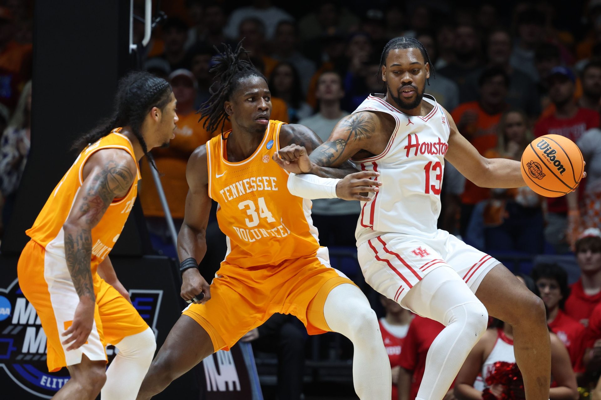 Mar 30, 2025; Indianapolis, IN, USA; Houston Cougars forward J'Wan Roberts (13) dribbles the ball against Tennessee Volunteers forward Felix Okpara (34) in the second half during the Midwest Regional final of the 2025 NCAA tournament at Lucas Oil Stadium.