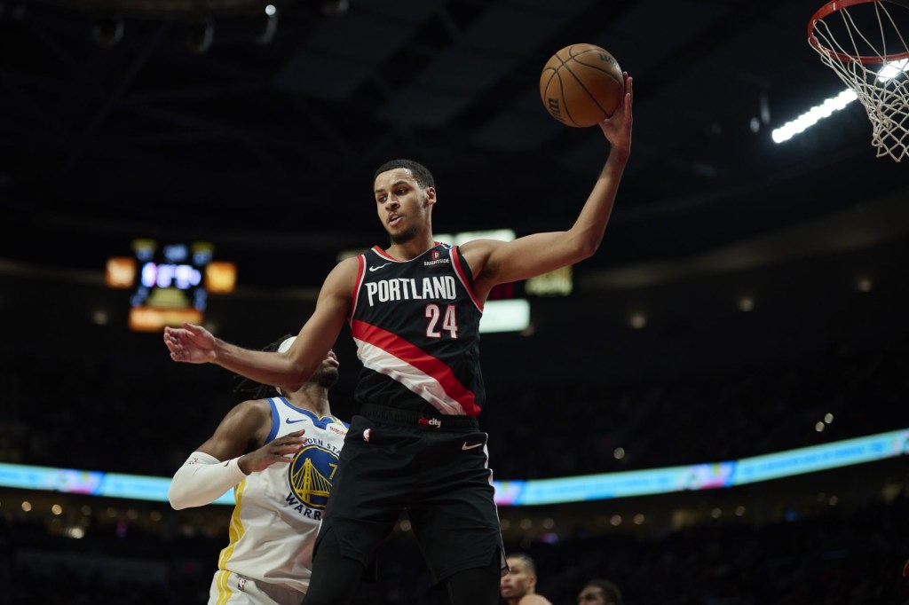 Apr 11, 2025; Portland, Oregon, USA; Portland Trail Blazers forward Kris Murray (24) grabs a rebound during the second half against Golden State Warriors guard Buddy Hield (7) at Moda Center.