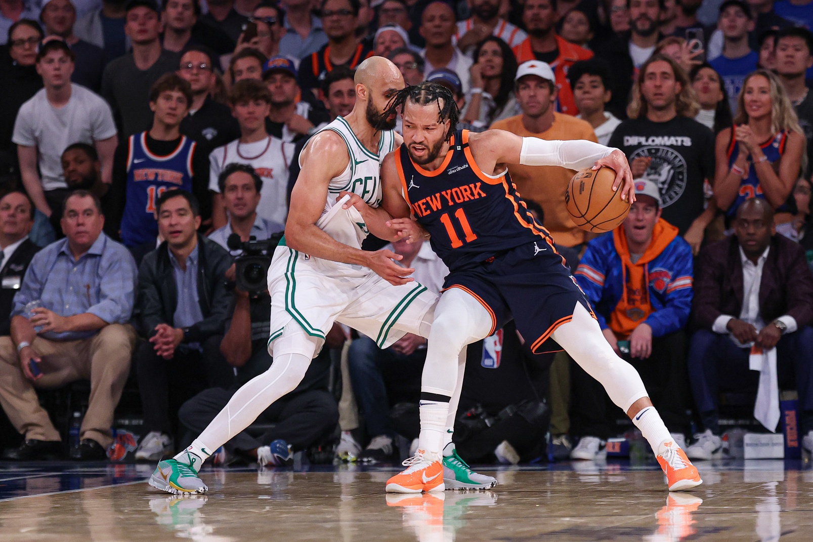 May 12, 2025; New York, New York, USA; New York Knicks guard Jalen Brunson (11) dribbles as Boston Celtics guard Derrick White (9) defends in the second half during game four of the second round for the 2025 NBA Playoffs at Madison Square Garden.