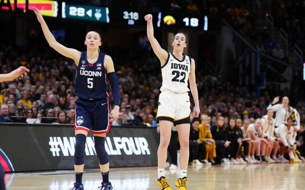 Apr 5, 2024; Cleveland, OH, USA; Iowa Hawkeyes guard Caitlin Clark (22) and Connecticut Huskies guard Paige Bueckers (5) react in the second quarter in the semifinals of the Final Four of the womens 2024 NCAA Tournament at Rocket Mortgage FieldHouse.