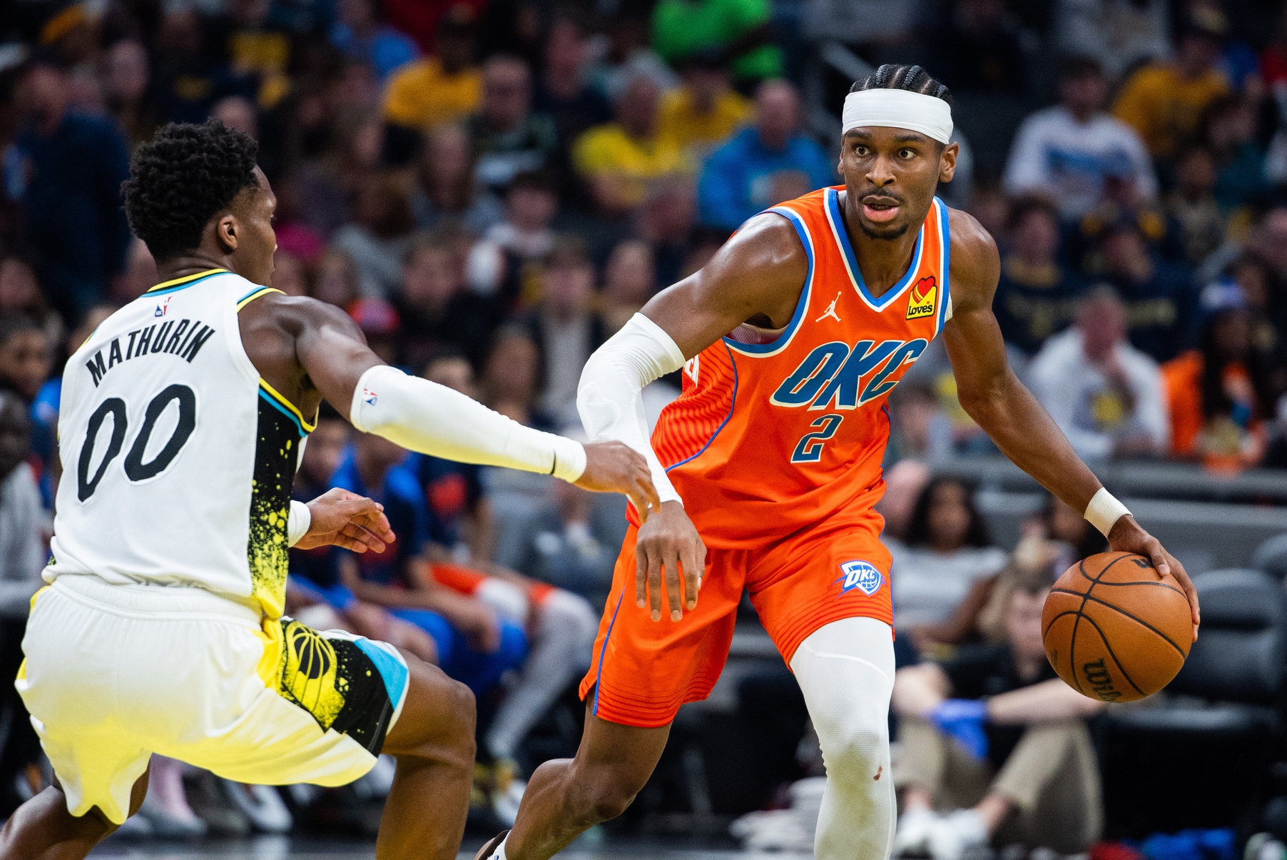 Dec 26, 2024; Indianapolis, Indiana, USA; Oklahoma City Thunder guard Shai Gilgeous-Alexander (2) dribbles the ball while Indiana Pacers guard Bennedict Mathurin (00) defends in the second half at Gainbridge Fieldhouse.