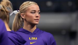 Mar 22, 2025; Birmingham AL, USA; LSU gymnast Livvy Dunne stretches with teammates before Session 2 of the SEC Gymnastics Tournament at Legacy Arena in Birmingham, Alabama.