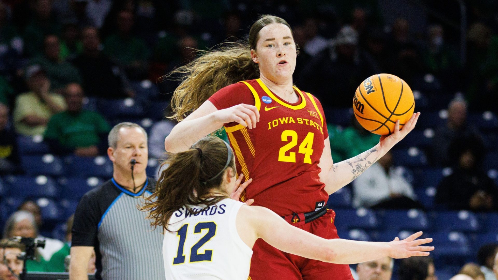 Iowa State forward Addy Brown (24) keeps the ball away from Michigan guard Syla Swords (12) during the first round of the NCAA Women's Basketball Tournament between Michigan and Iowa State at Purcell Pavilion on Friday, March 21, 2025, in South Bend.