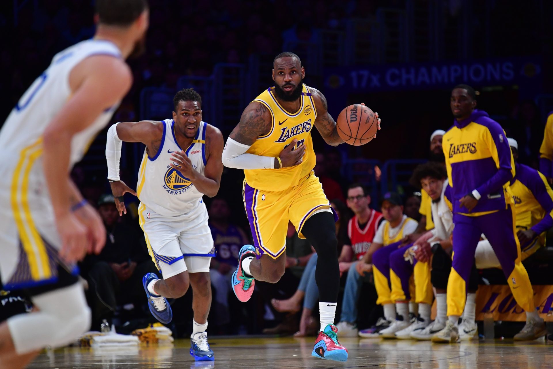 Apr 3, 2025; Los Angeles, California, USA; Los Angeles Lakers forward LeBron James (23) moves the ball up court ahead of Golden State Warriors forward Kevon Looney (5) during the first half at Crypto.com Arena.