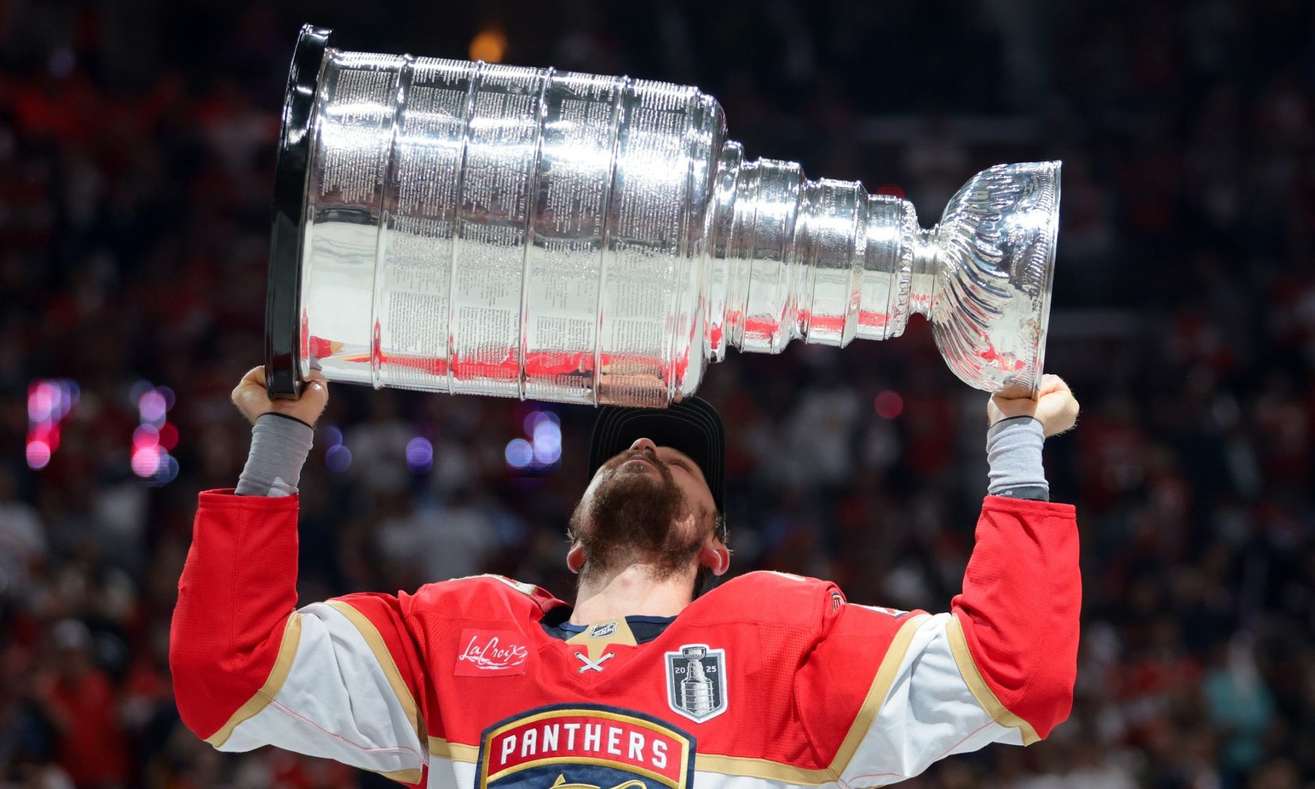 Jun 17, 2025; Sunrise, Florida, USA; Florida Panthers center Sam Reinhart (13) hoists the Stanley Cup after winning game six of the 2025 Stanley Cup Final against the Edmonton Oilers at Amerant Bank Arena