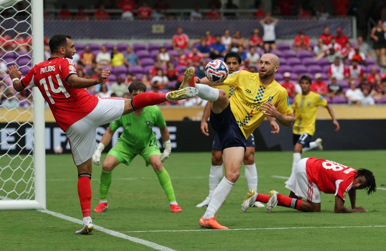 Jun 20, 2025; Orlando, Florida, USA; SL Benfica forward Evangelos Pavlidis (14) in action with Auckland City FC defender Christian Gray (4) during a group stage match of the 2025 FIFA Club World Cup at Inter&Co Stadium.