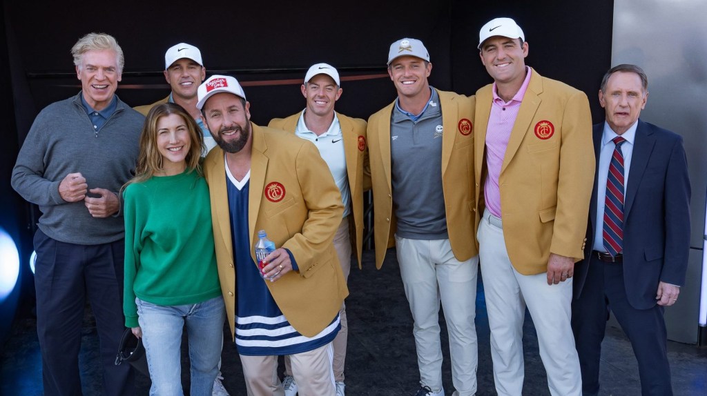 HAPPY GILMORE 2. - BTS - (L to R) Christopher McDonald as Shooter McGavin, Brooks Koepka as Himself, Jackie Sandler as Monica, Adam Sandler as Happy Gilmore (Writer/Producer), Rory McIlroy as Himself, Bryson DeChambeau as Himself, Scottie Scheffler as Himself and Dennis Dugan as Doug Thompson on the set of Happy Gilmore2.