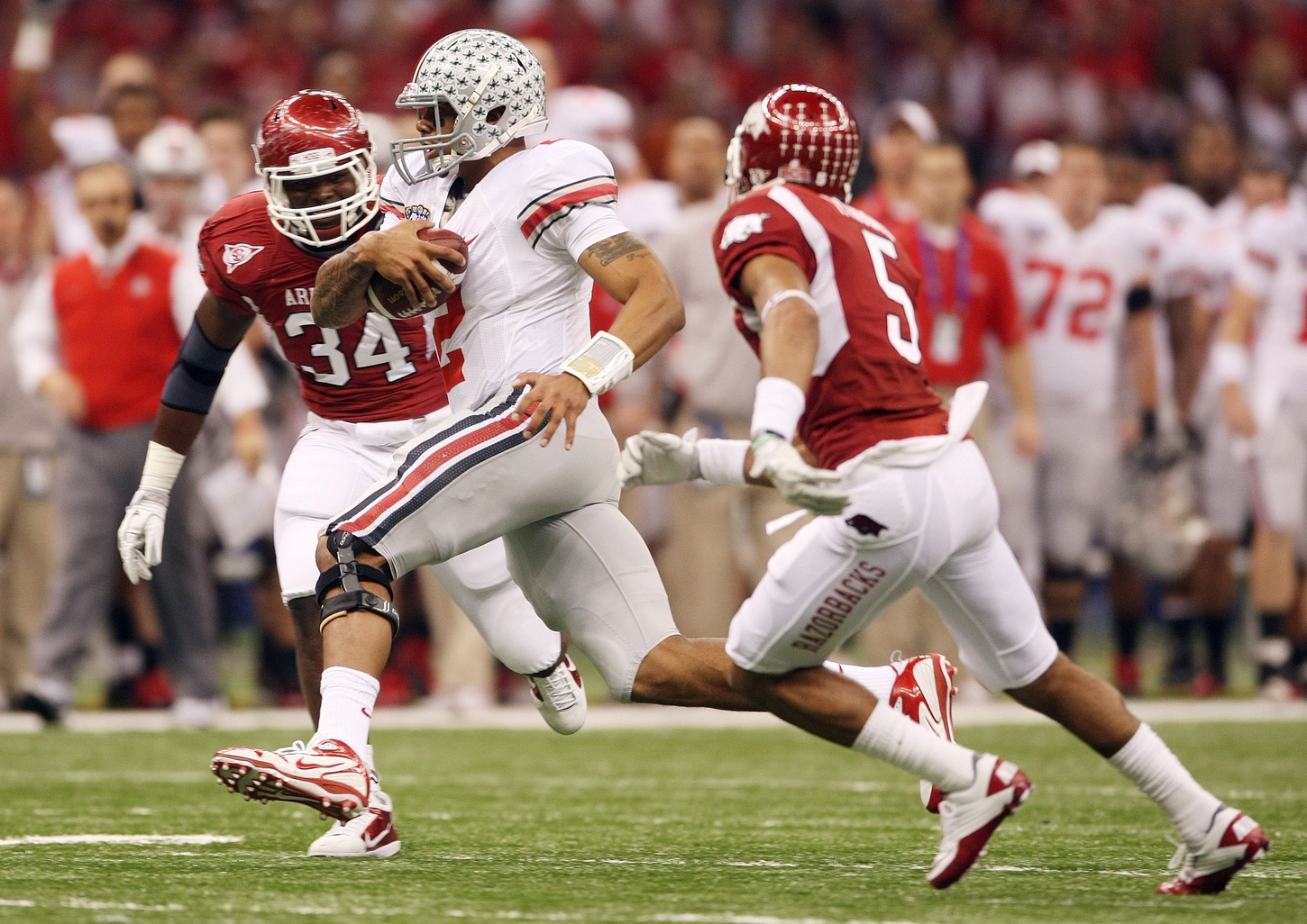 (NCL_OSU_11_SUGAR_LAURON 04JAN11) Ohio State Buckeyes quarterback Terrelle Pryor (2) slips around the Arkansas Razorbacks defense during first half of the Sugar Bowl at the Louisiana Superdome in New Orleans, January 4, 2011.