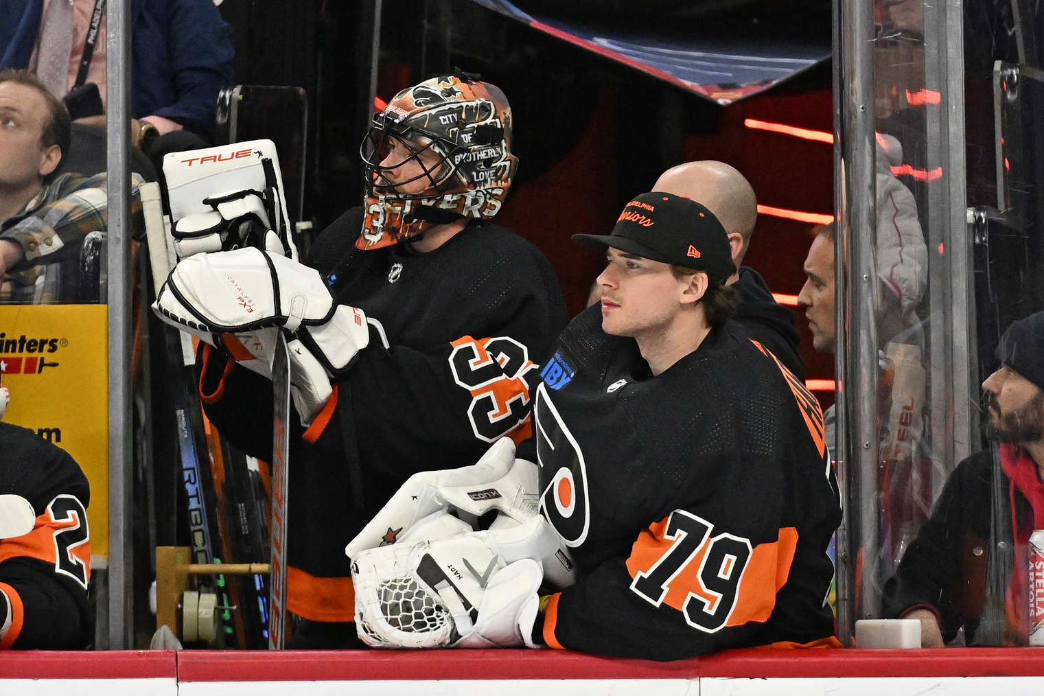 Jan 21, 2024; Philadelphia, Pennsylvania, USA; Philadelphia Flyers goaltender Samuel Ersson (33) and goaltender Carter Hart (79) watch from the bench against the Ottawa Senators during the third period at Wells Fargo Center.