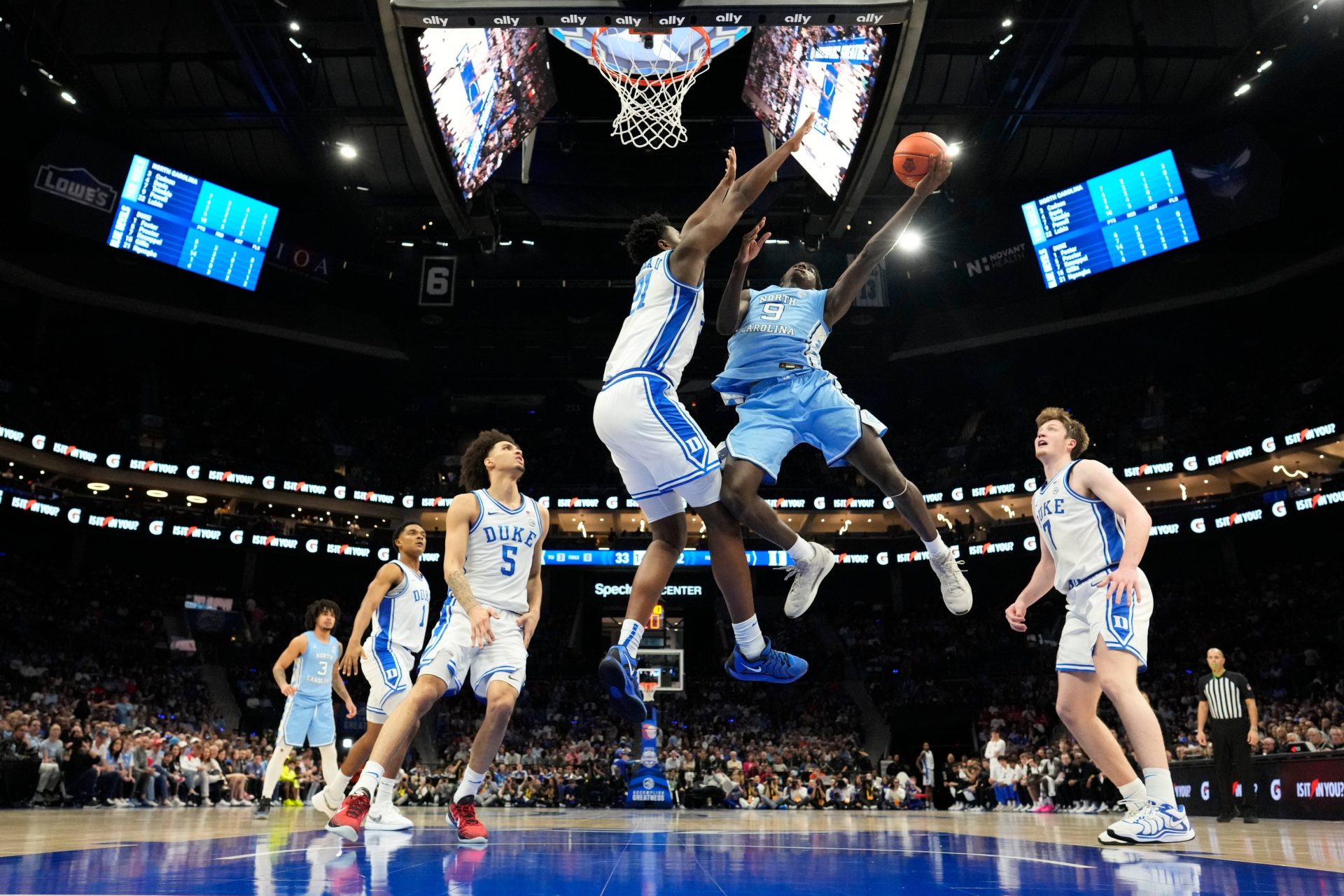 Mar 14, 2025; Charlotte, NC, USA; North Carolina Tar Heels guard Drake Powell (9) shoots as Duke Blue Devils center Patrick Ngongba II (21) defends in the second half at Spectrum Center